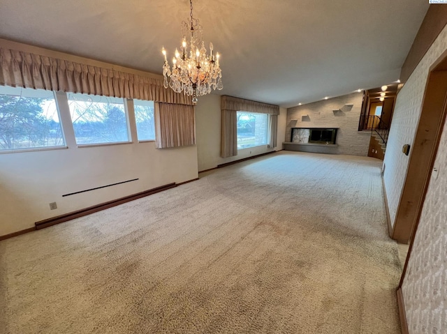 unfurnished living room with baseboard heating, a glass covered fireplace, carpet flooring, vaulted ceiling, and baseboards