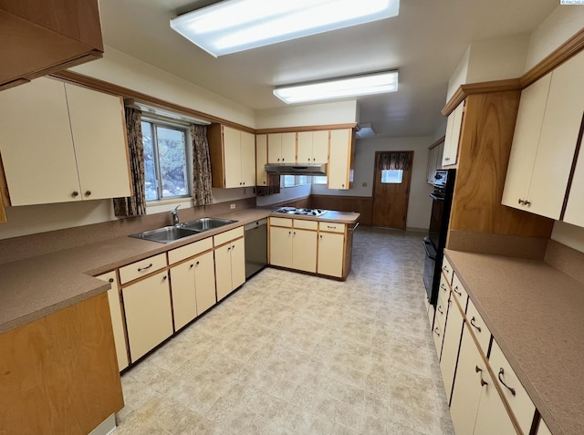 kitchen with light floors, under cabinet range hood, a sink, light countertops, and black appliances