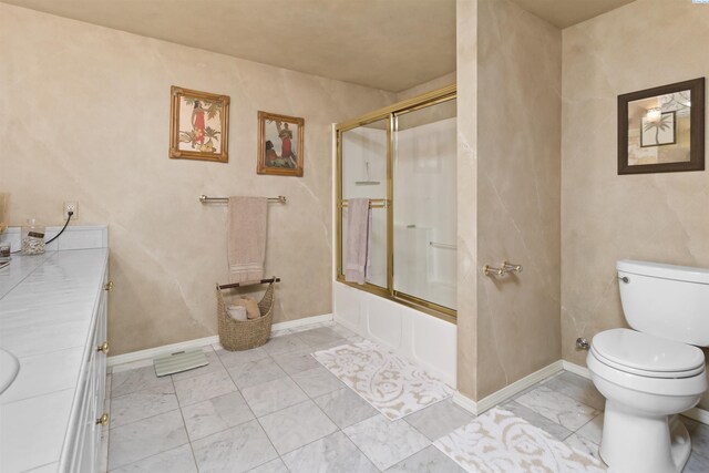 full bathroom featuring vanity, bath / shower combo with glass door, and toilet