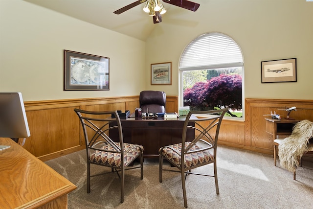 carpeted home office with lofted ceiling and ceiling fan