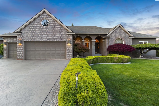 view of front facade featuring a garage and a lawn