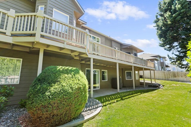 rear view of property with a patio area and a lawn