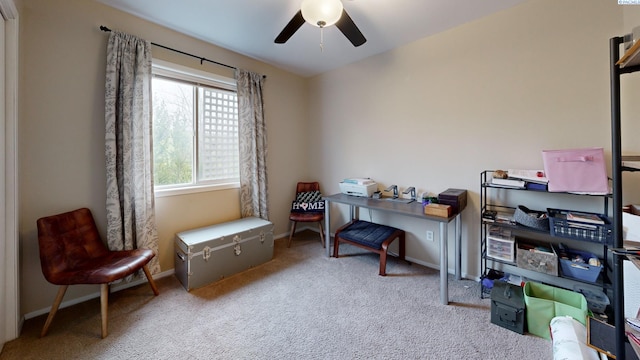 carpeted office with baseboards and a ceiling fan