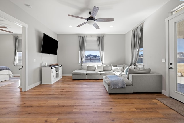 living room featuring ceiling fan and hardwood / wood-style floors