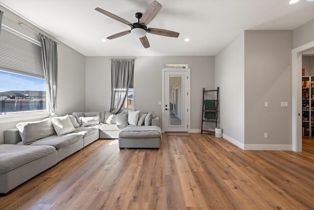 living room featuring ceiling fan and light wood-type flooring