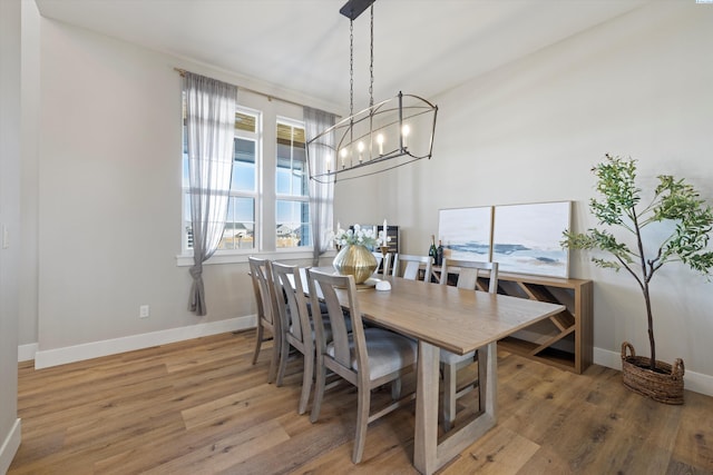 dining space featuring an inviting chandelier and hardwood / wood-style floors