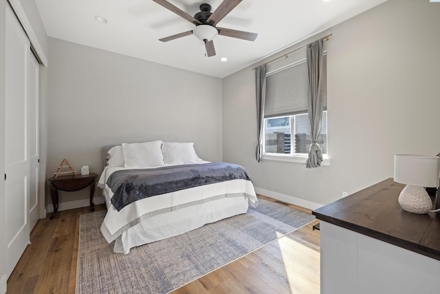 bedroom featuring wood-type flooring, a closet, and ceiling fan