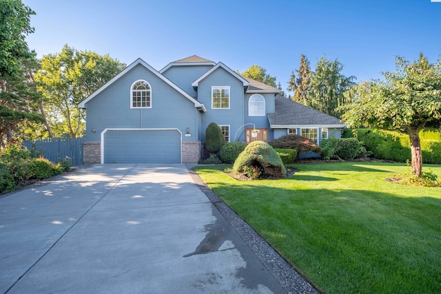 view of property featuring a garage and a front yard