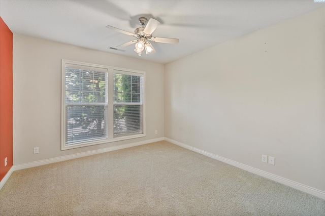 unfurnished room featuring carpet flooring, baseboards, and a ceiling fan
