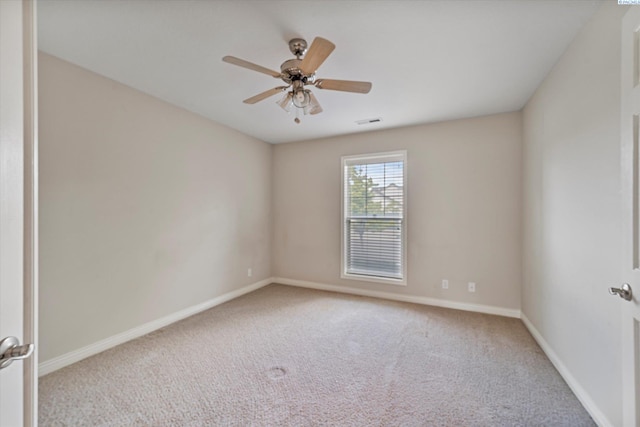 carpeted empty room with baseboards and a ceiling fan