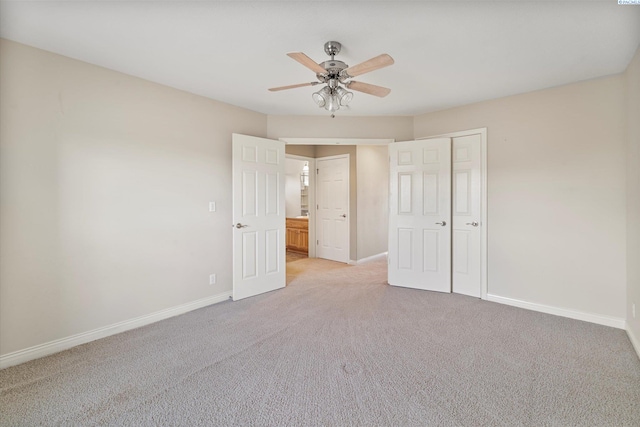 unfurnished bedroom featuring light carpet, baseboards, and ceiling fan