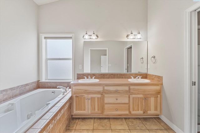bathroom featuring tile patterned floors, a bath, and double vanity