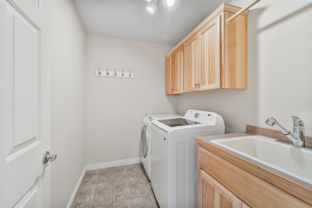 laundry room with washer and clothes dryer, baseboards, cabinet space, and light stone finish floors