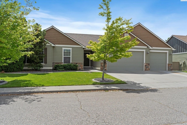 craftsman inspired home with stone siding, an attached garage, driveway, and a front lawn