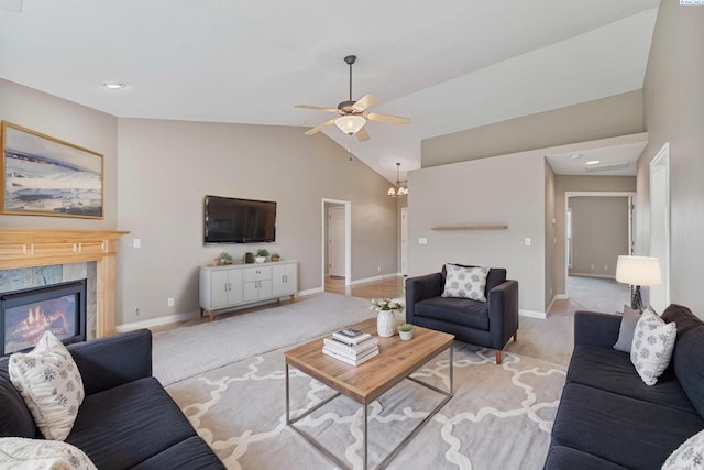 living room featuring light colored carpet, lofted ceiling, baseboards, a ceiling fan, and a high end fireplace