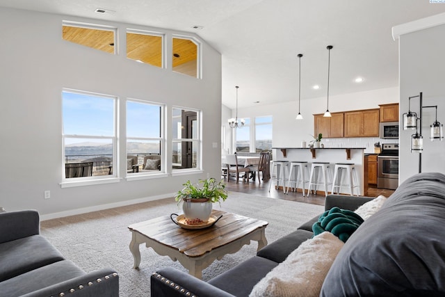 living room with an inviting chandelier and high vaulted ceiling