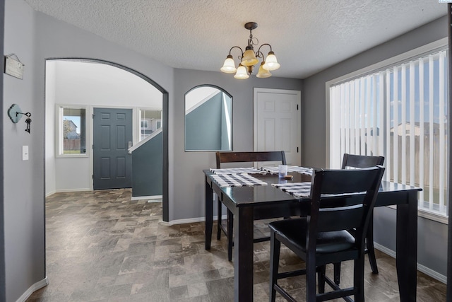 6115 Wildcat Ln, Pasco, WA 99301 - dining room with baseboards, a chandelier, and plenty of natural light