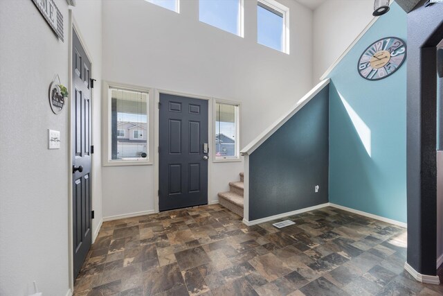 6115 Wildcat Ln, Pasco, WA 99301 - entrance foyer with a towering ceiling, baseboards, visible vents, stone finish flooring, and stairs