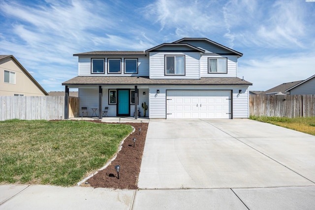 6115 Wildcat Ln, Pasco, WA 99301 - traditional-style home featuring a porch, concrete driveway, fence, a garage, and a front yard
