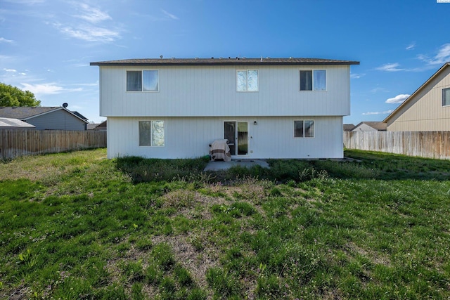 6115 Wildcat Ln, Pasco, WA 99301 - back of house with a lawn and a fenced backyard