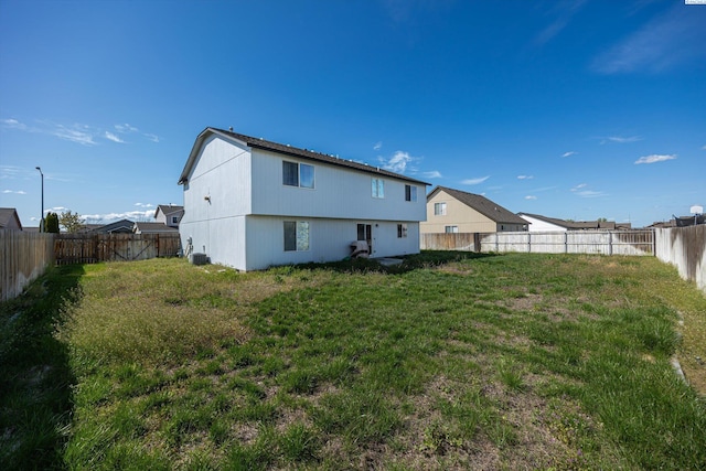 6115 Wildcat Ln, Pasco, WA 99301 - rear view of house with a fenced backyard and a lawn