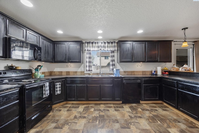 6115 Wildcat Ln, Pasco, WA 99301 - kitchen with dark countertops, a sink, recessed lighting, and black appliances