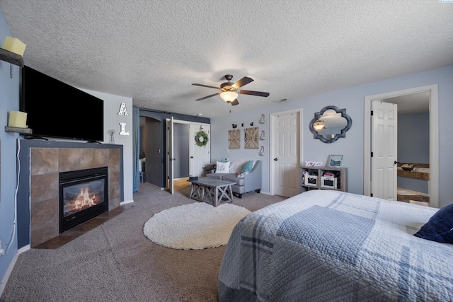 6115 Wildcat Ln, Pasco, WA 99301 - carpeted bedroom featuring a tile fireplace, baseboards, a textured ceiling, and ceiling fan