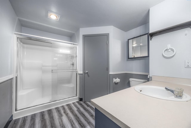 8307 Camano Dr, Pasco, WA 99301 - bathroom with a stall shower, vanity, and wood finished floors