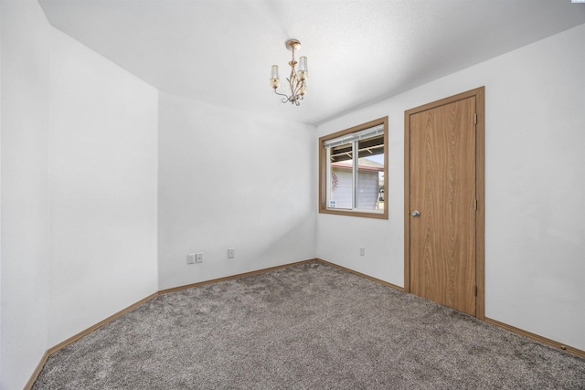 8307 Camano Dr, Pasco, WA 99301 - carpeted empty room with a chandelier and baseboards