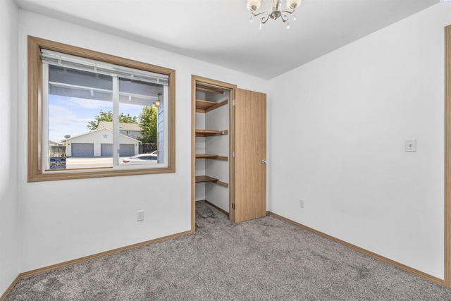 8307 Camano Dr, Pasco, WA 99301 - unfurnished bedroom with carpet, a chandelier, a walk in closet, and a closet