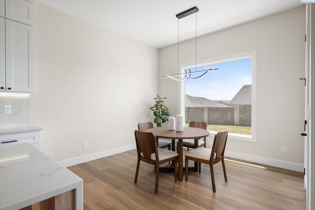 561 Lazio Way, Richland, WA 99352 - dining area featuring light wood finished floors, a chandelier, and baseboards
