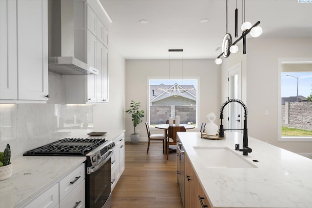 561 Lazio Way, Richland, WA 99352 - kitchen featuring stainless steel appliances, wall chimney exhaust hood, a sink, decorative backsplash, and dark wood-type flooring