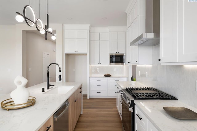 561 Lazio Way, Richland, WA 99352 - kitchen featuring stainless steel appliances, a sink, wall chimney range hood, light stone counters, and dark wood-style floors