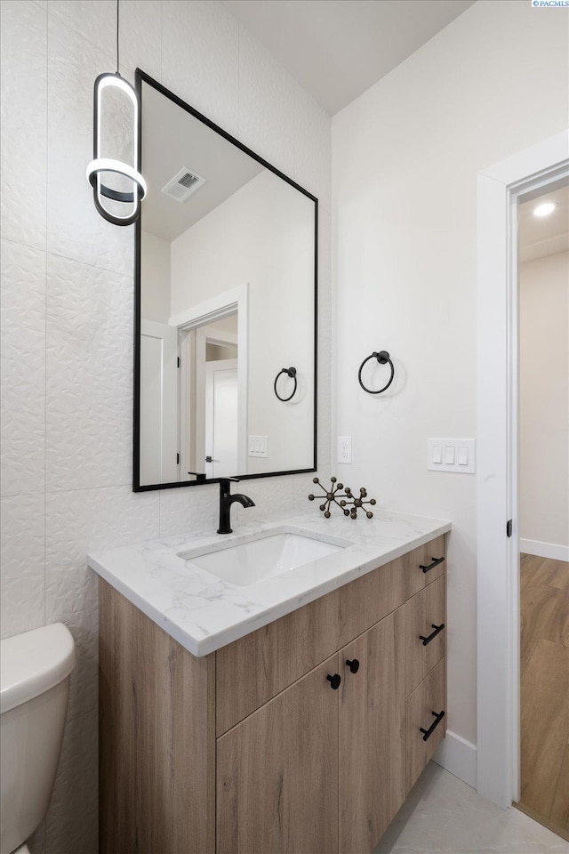 561 Lazio Way, Richland, WA 99352 - bathroom with toilet, vanity, and baseboards