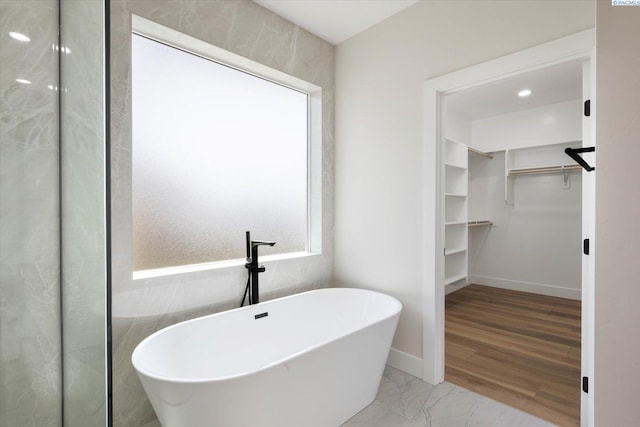 561 Lazio Way, Richland, WA 99352 - bathroom with a spacious closet, a soaking tub, marble finish flooring, and baseboards