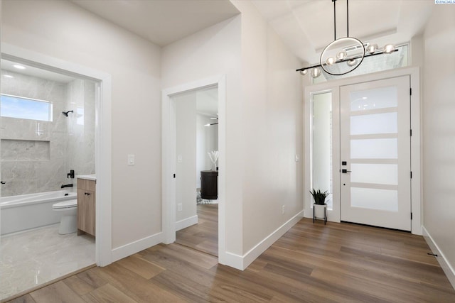 561 Lazio Way, Richland, WA 99352 - entrance foyer with wood finished floors, a chandelier, and baseboards