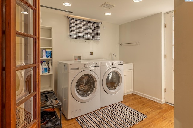 525 SE Water St, Pullman, WA 99163 - clothes washing area featuring light wood-type flooring, visible vents, recessed lighting, washer and dryer, and cabinet space