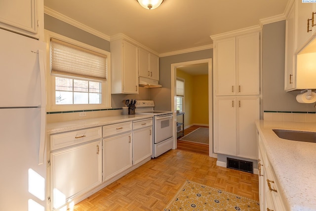 525 SE Water St, Pullman, WA 99163 - kitchen with under cabinet range hood, white appliances, visible vents, and ornamental molding