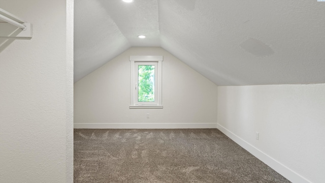 215 E Oak St, Walla Walla, WA 99362 - additional living space with a textured ceiling, baseboards, recessed lighting, vaulted ceiling, and carpet