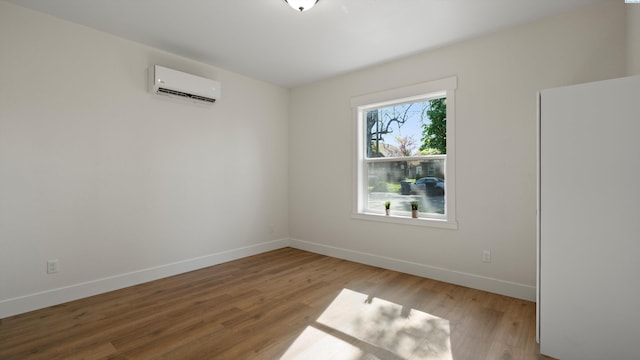215 E Oak St, Walla Walla, WA 99362 - unfurnished room featuring wood finished floors, a wall mounted air conditioner, and baseboards
