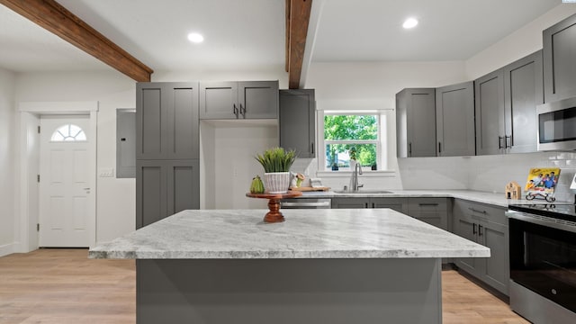 215 E Oak St, Walla Walla, WA 99362 - kitchen featuring appliances with stainless steel finishes, tasteful backsplash, beamed ceiling, and gray cabinets