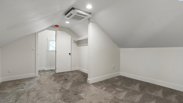 215 E Oak St, Walla Walla, WA 99362 - bonus room featuring carpet floors, vaulted ceiling, baseboards, visible vents, and a textured ceiling