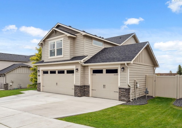 2855 S Dawes Pl, Kennewick, WA 99338 - view of front of house featuring board and batten siding, a front yard, fence, concrete driveway, and stone siding