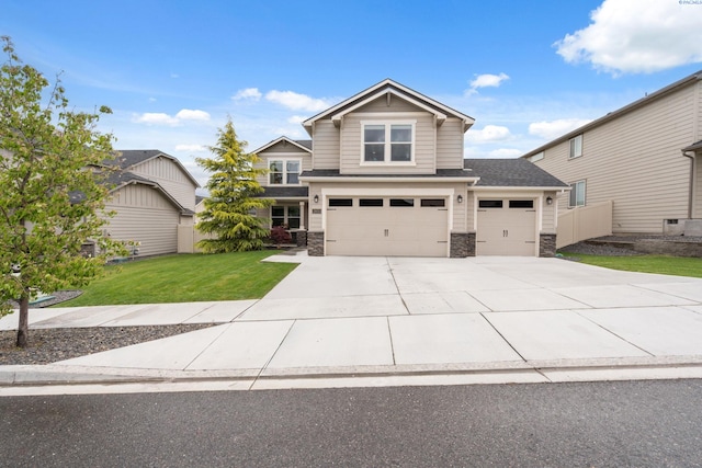 2855 S Dawes Pl, Kennewick, WA 99338 - craftsman house with fence, an attached garage, stone siding, a front yard, and driveway