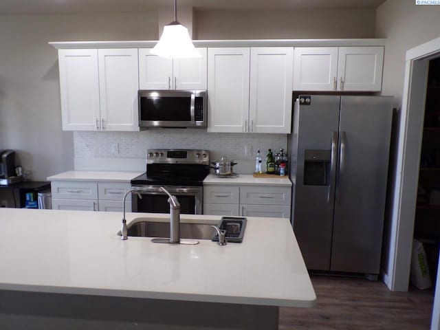 166214 W Johnson Rd, Prosser, WA 99350 - kitchen with stainless steel appliances, white cabinetry, backsplash, and light countertops