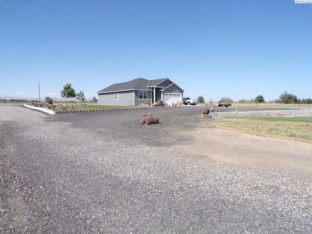 166214 W Johnson Rd, Prosser, WA 99350 - view of front of property with a garage, driveway, and a rural view