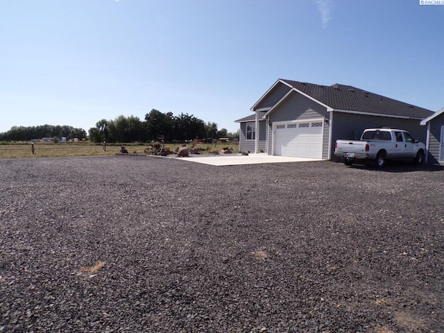 166214 W Johnson Rd, Prosser, WA 99350 - view of yard with a garage and concrete driveway
