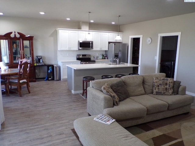 166214 W Johnson Rd, Prosser, WA 99350 - living area featuring recessed lighting, washer / dryer, and light wood-style floors