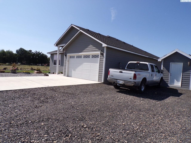 166214 W Johnson Rd, Prosser, WA 99350 - view of property exterior featuring concrete driveway and a garage