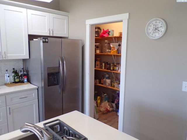 166214 W Johnson Rd, Prosser, WA 99350 - kitchen with stainless steel fridge with ice dispenser, white cabinetry, backsplash, and light countertops